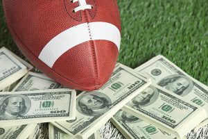 Money, football field and football