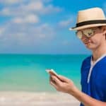 Person using a USA sportsbook site on the beach in Florida.