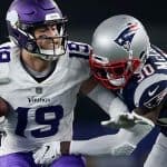 Minnesota Vikings wide receive Adam Thielen trying to evade a New England Patriots defender