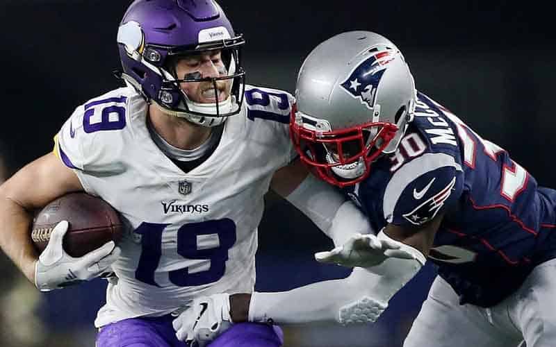 Minnesota Vikings wide receive Adam Thielen trying to evade a New England Patriots defender