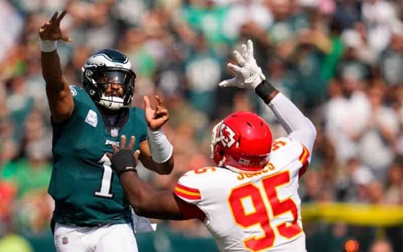 Christopher Jones of the Kansas City Chiefs trying to sack Jalen Hurts of the Philadelphia Eagles