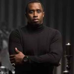 Diddy in a black turtleneck crossing his arms
