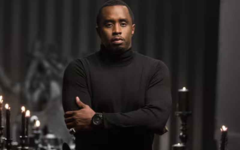 Diddy in a black turtleneck crossing his arms